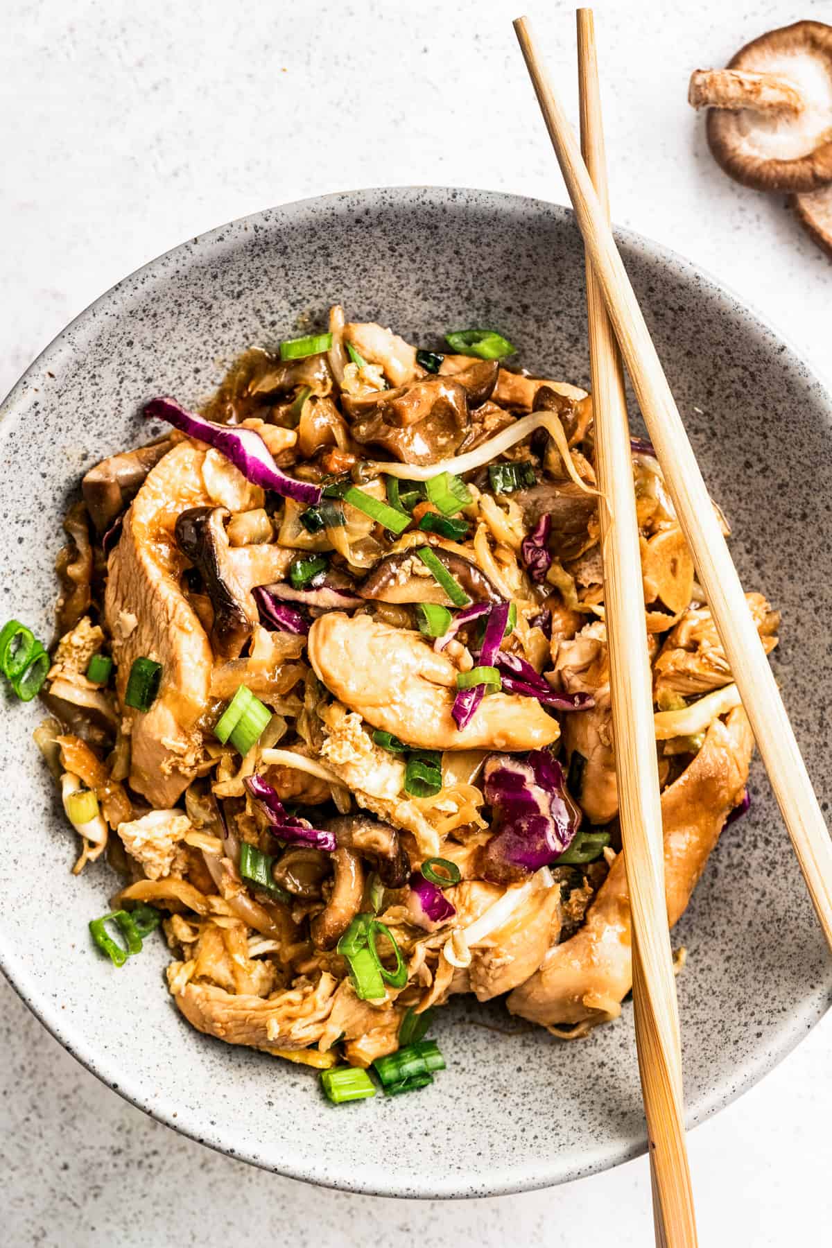 Moo shu chicken in a bowl with chopsticks.