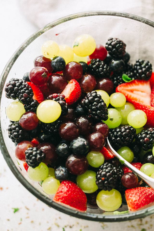 Moscato Fruit Salad - Prepared with colorful grapes and berries, this light, boozy, and delicious fresh fruit salad makes the perfect accompaniment to your summer nights!