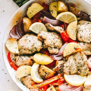 Chicken and veggies in the skillet with lemon-garlic marinade.