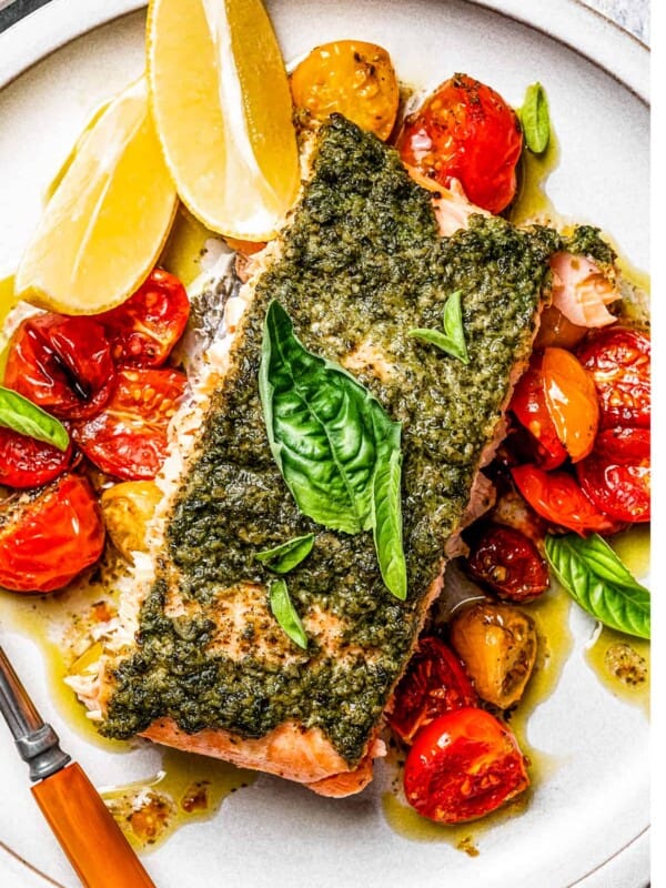 A dinner plate served with roasted cherry tomatoes and salmon.