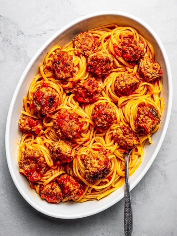 Overhead view of a large platter of spaghetti and pork meatballs.