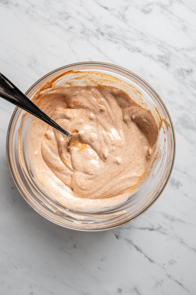 Lemon-garlic aioli for potato croquettes in a bowl.