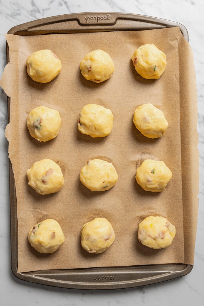 Bacon-chive-cheddar mashed potatoes formed into balls to make potato croquettes.