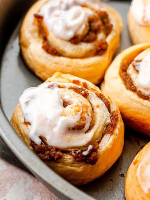 side shot of pumpkin pie cinnamon rolls in a cake pan