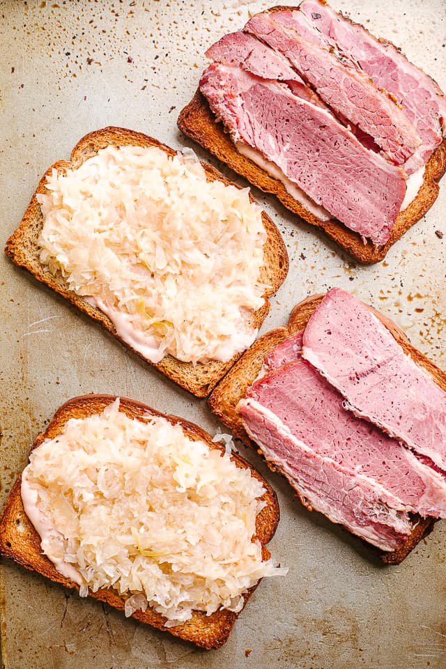 layer corned beef and sauerkraut on rye bread