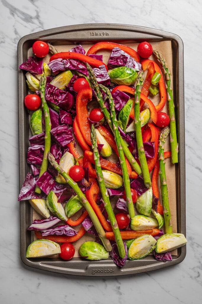 Raw veggies on the baking sheet. 