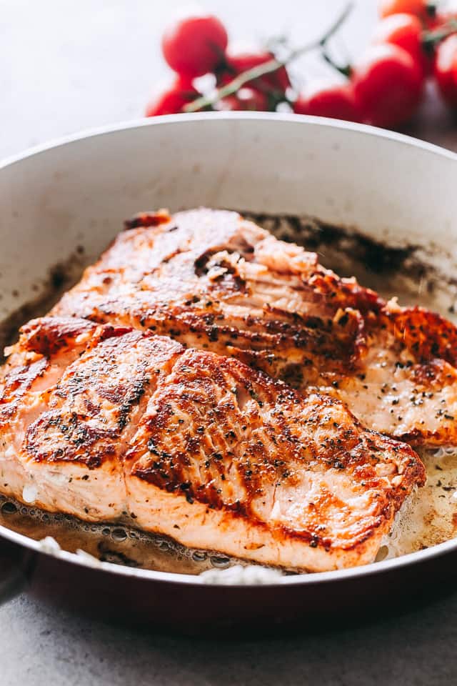 Pan Seared Salmon fillets in a skillet.