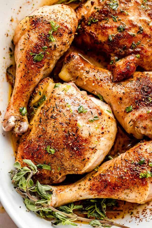 close up overhead shot of browned chicken drumsticks and chicken thighs