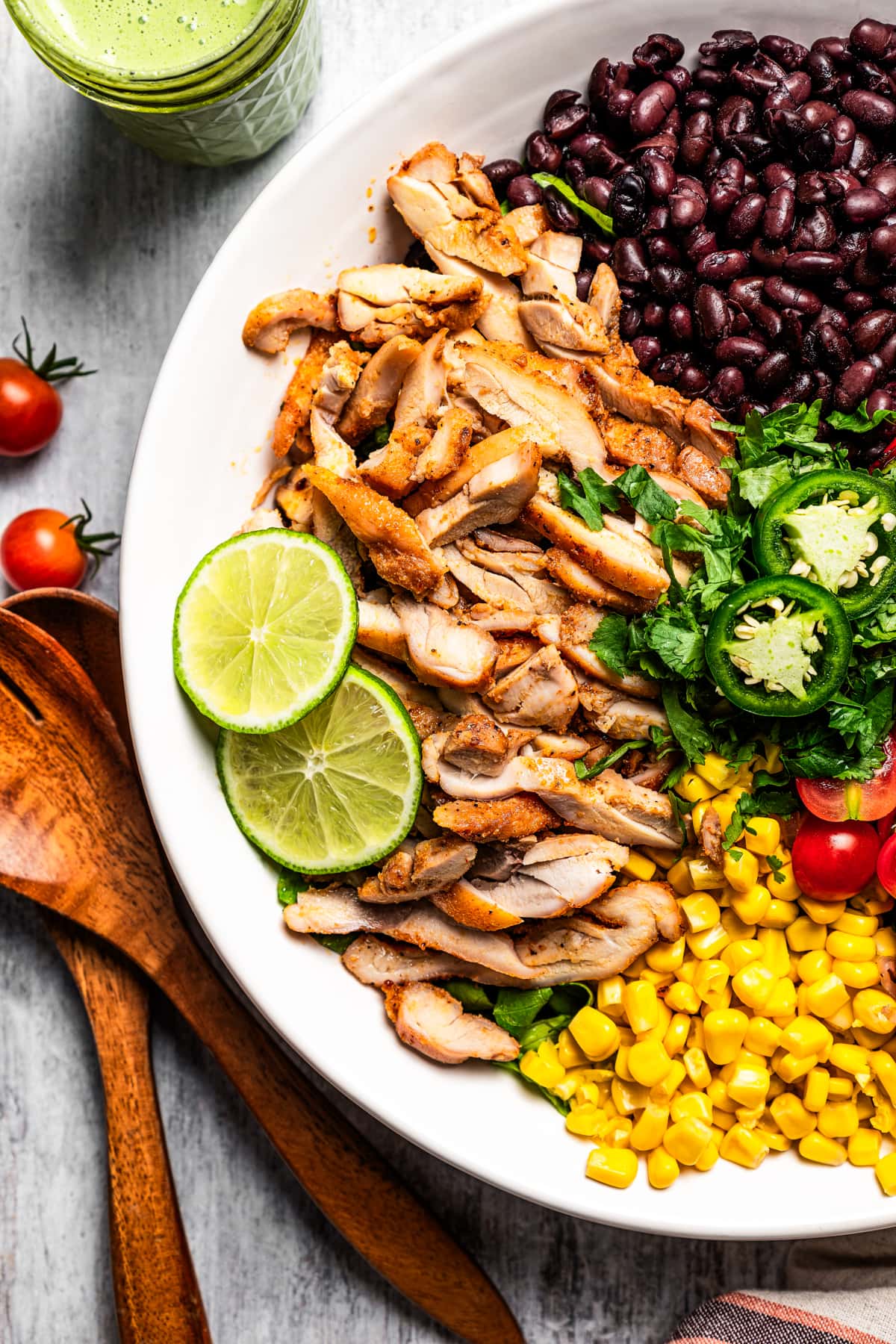 Assembling southwestern chicken salad in a bowl before dressing.