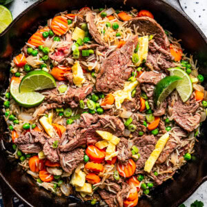 Cooked steak fried rice in a black cast iron skillet.