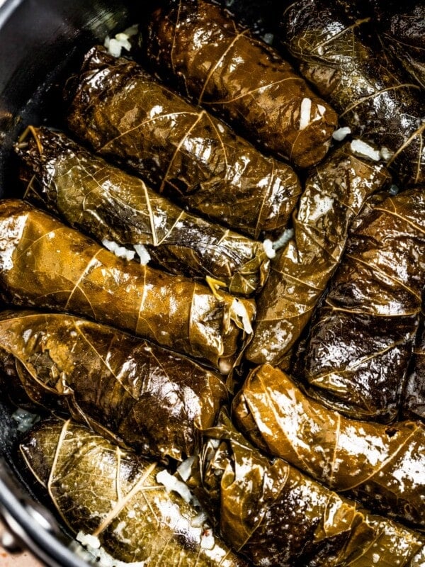 Cooked stuffed grape leaves in a pot.