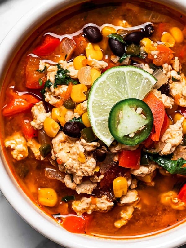 Easy taco soup in a bowl with a lime wedge, jalapeño, and cilantro on top.