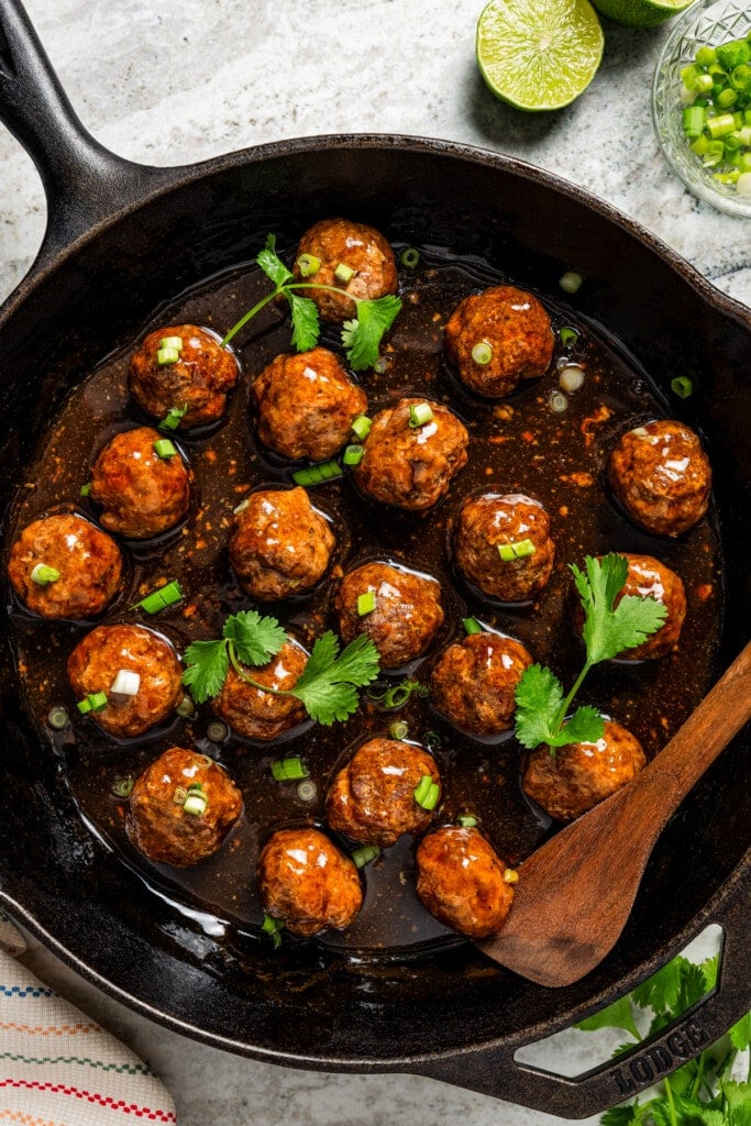 A skillet with meatballs in homemade teriyaki sauce.