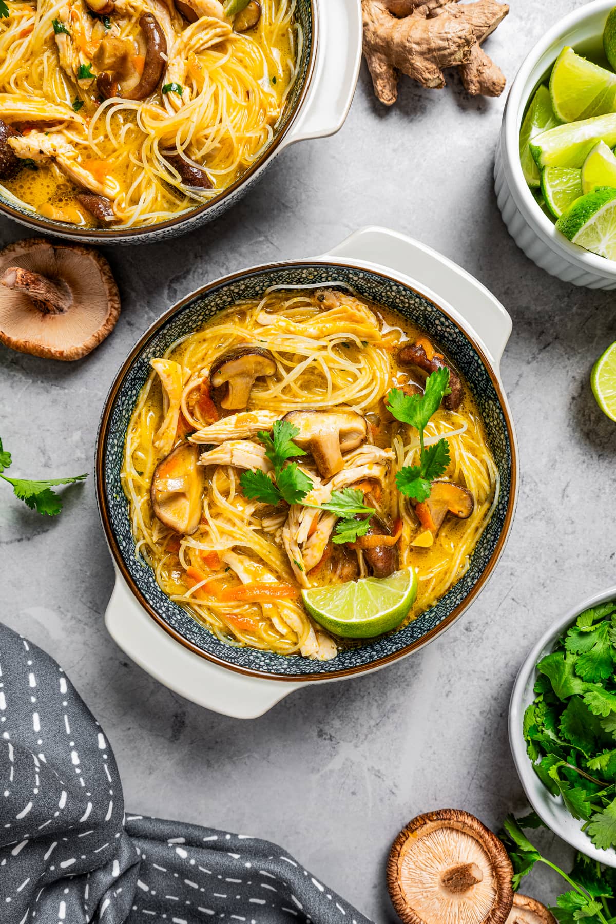 Overhead image of two bowls of Thai chicken soup.