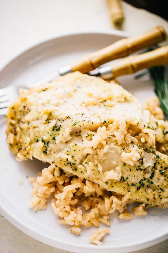 One Pan Risotto with Garlic Herb Tilapia – Delicious, garlicky tilapia set over a flavorful bed of rice, all baked to a creamy perfection!